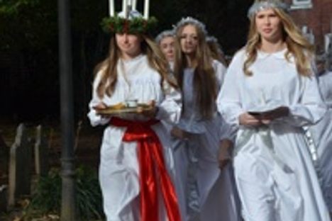 Young women dressed in traditional attire for the feast of St. Lucia.