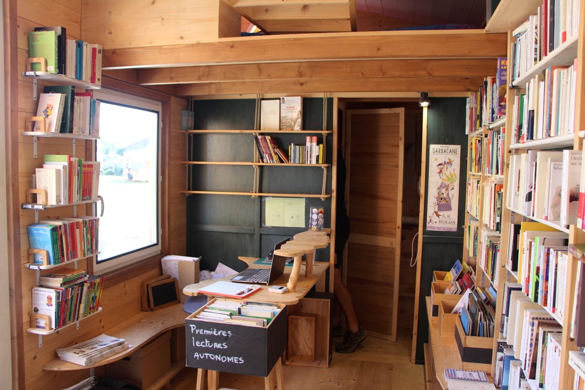 The register of the bookshop (left), the entrance to a small private area (center), and Megel-Nuber's sleeping loft (top).
