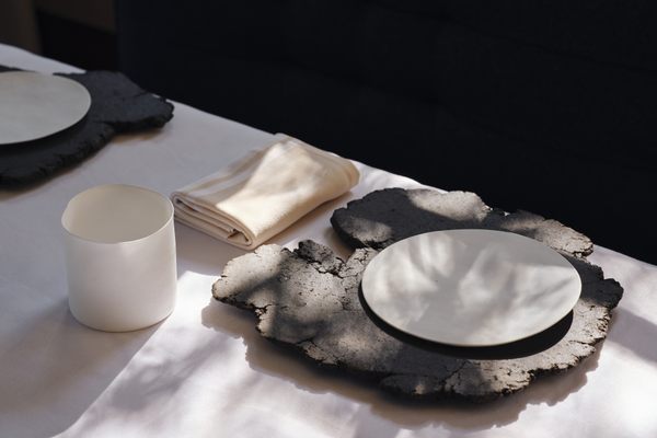 A place setting at Blue Hill at Stone Barns includes Moore’s bone china water cup and plate as well as a charger made from soil. 