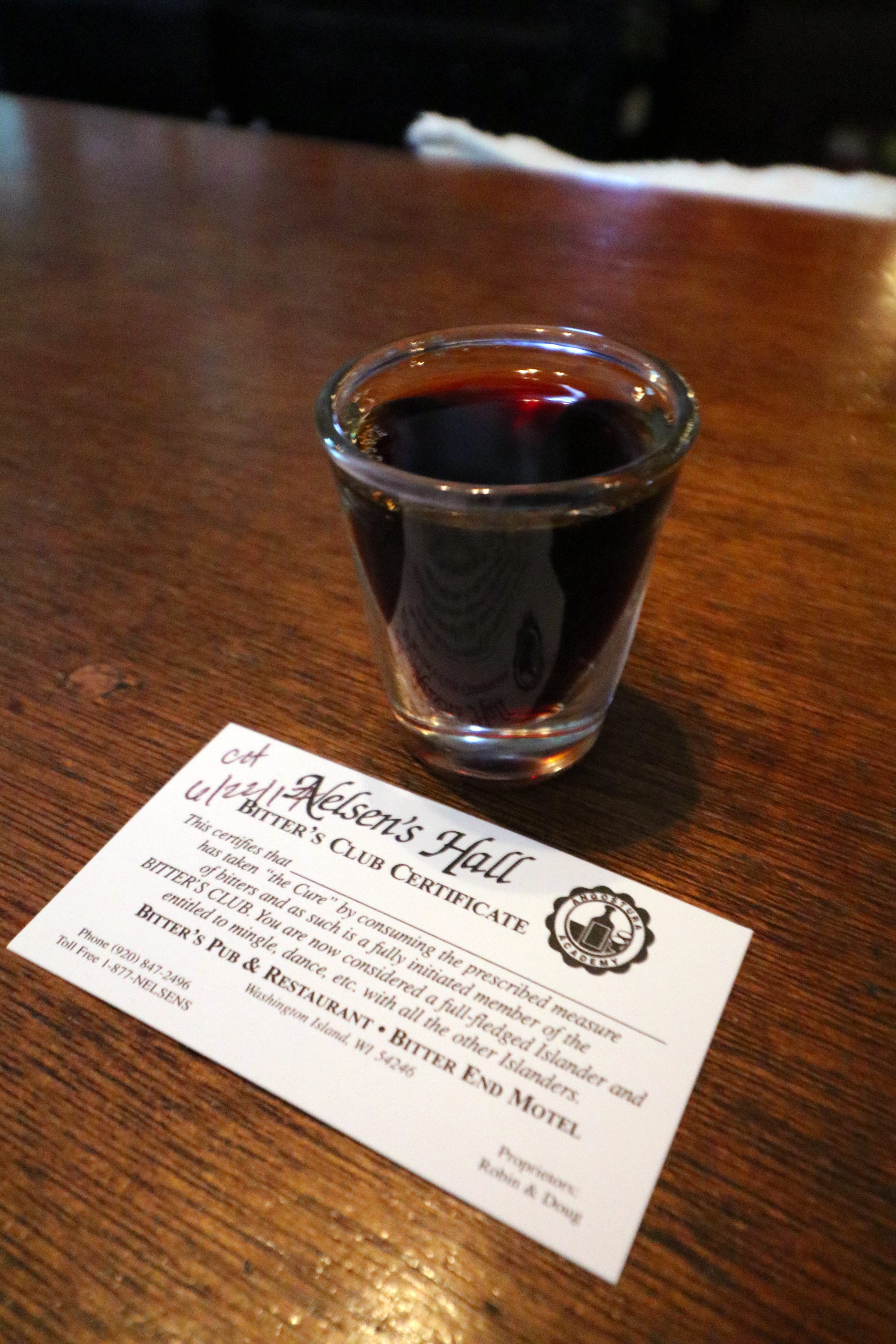 A shot of bitters, and a card inaugurating someone into the Bitter's Club.