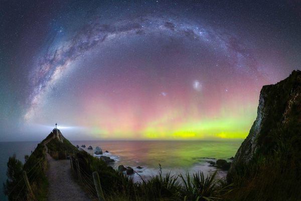 The Milky Way and curtain-like auroras fill a clear southern sky off Nugget Point, at the edge of New Zealand’s remote Catlins. While the island nation is too far north to see the aurora australis regularly, aurora-hunters flock to the Nugget Point lighthouse area for its dark skies and unobstructed view off the South Island’s southeastern coast.