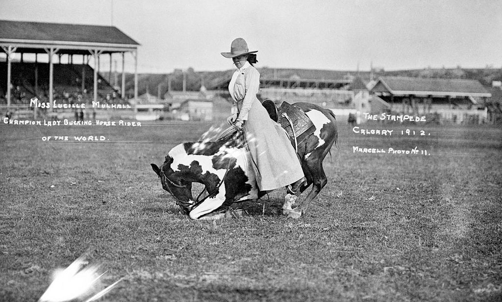 Lucille Mulhall with her kneeing horse at the Calgary Stampede, 1912