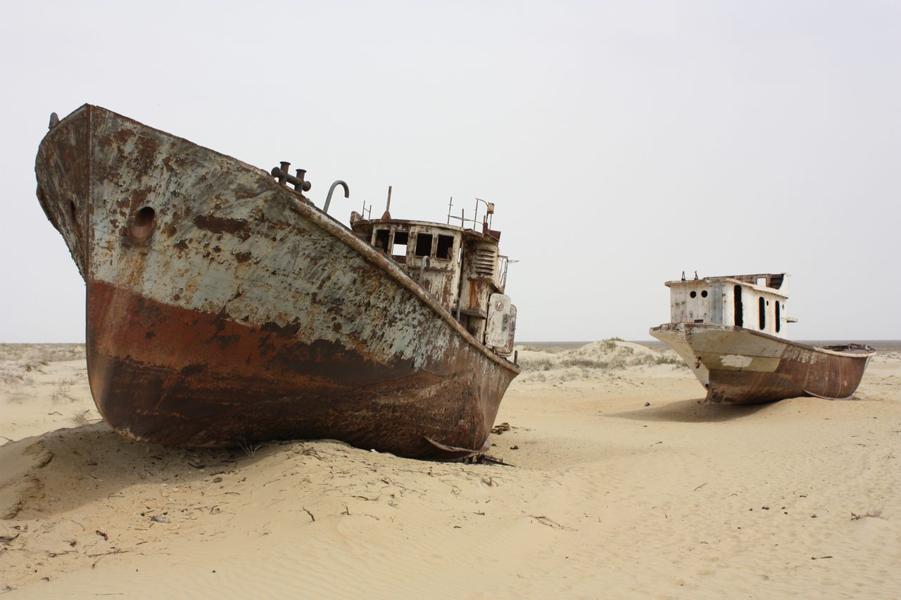 Two fishing vessels nestled in the sands near the former seaport city of Moynaq, Uzbekistan. 