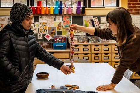Stitch Buffalo refugee artisan delivering new work. 