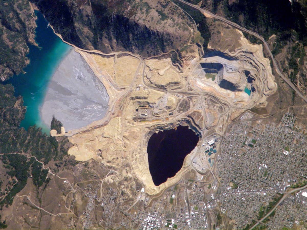 The Berkeley Pit, seen from the International Space Station in 2006, appears as a dark wedge in the center of the image, with the city of Butte fanning out to the lower right.
