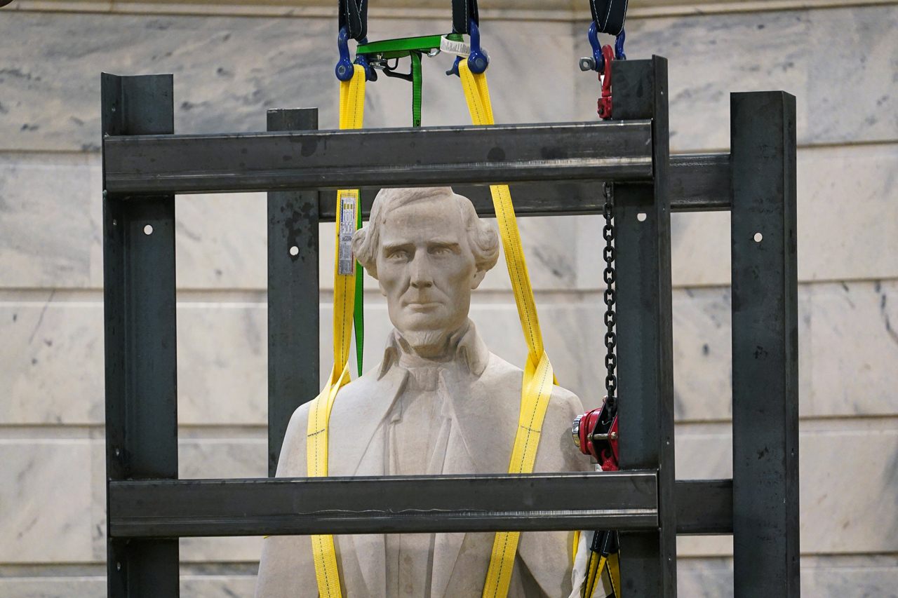 A statue of Confederate President Jefferson Davis is removed from the rotunda of the Capitol Building in Frankfort, Kentucky, on June 13, 2020. 