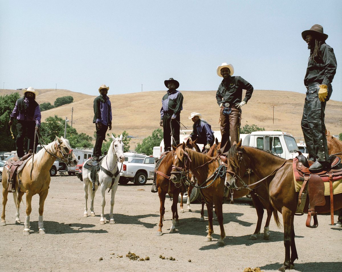 Joseph “Dugga” Matthews (far right) and other riders stand on their horses in 2008.