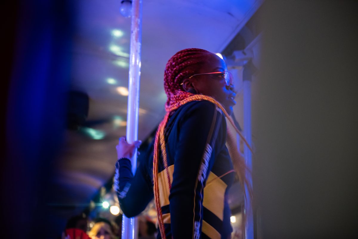 A Flex dancer makes her way through another car.