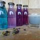 A chai-and-butterfly-pea periwinkle latte, alongside other colored drinks.