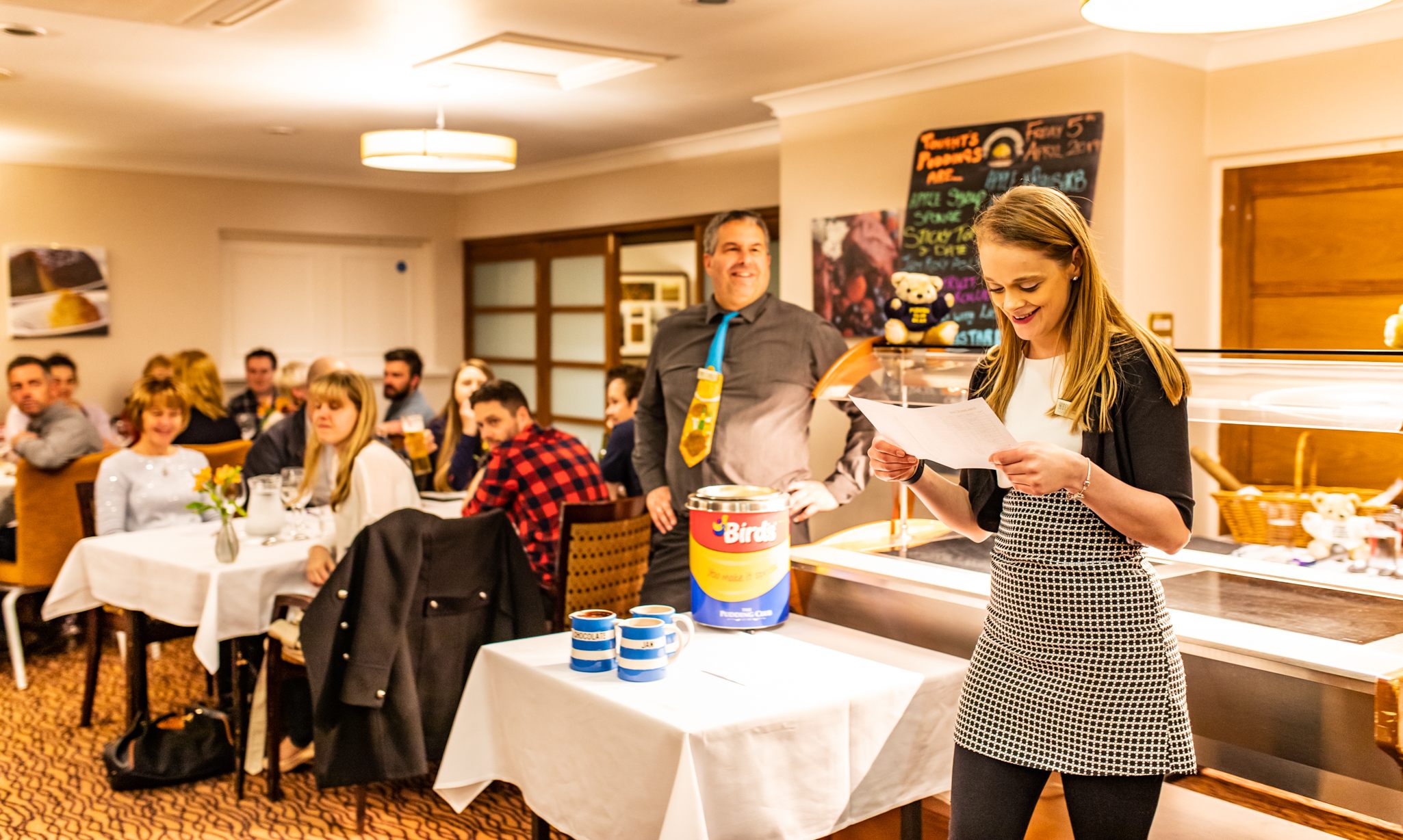 Lucy Williams, the Pudding Master, announcing the puddings of the night.