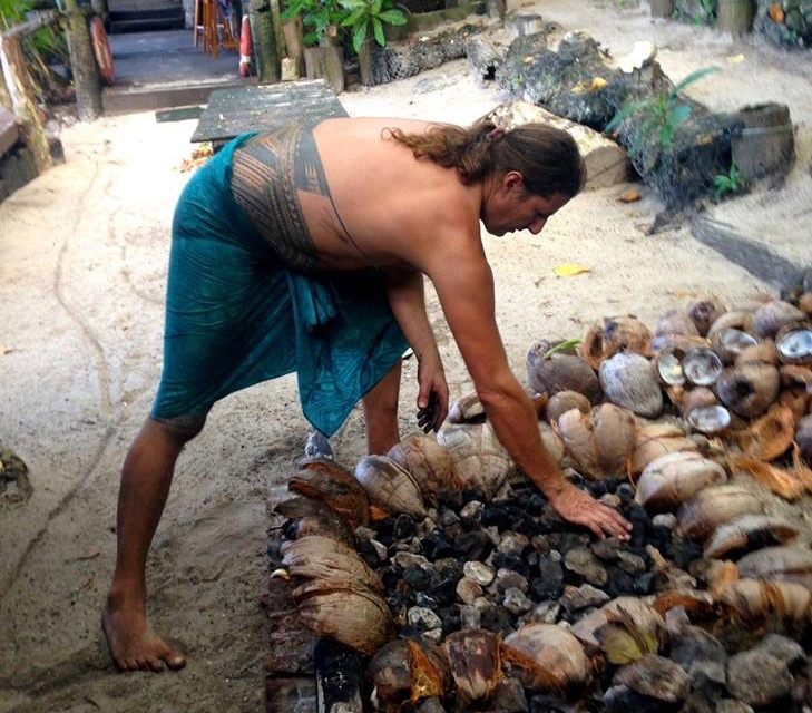 Candyman prepares the umu rock bed for cooking.