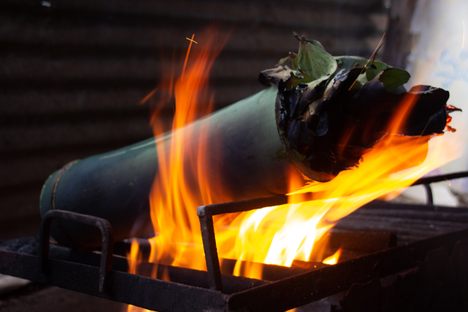 At Dombo's food stall in Araku, bamboo biryani cooks over an open flame.