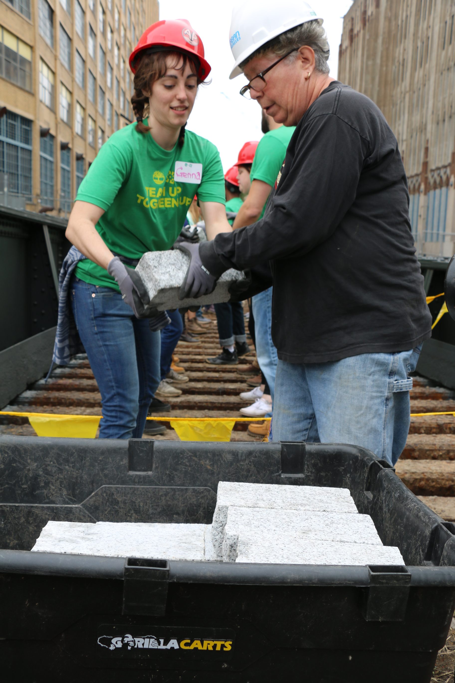 An assembly line moves concrete pavers along the old rail tracks. 