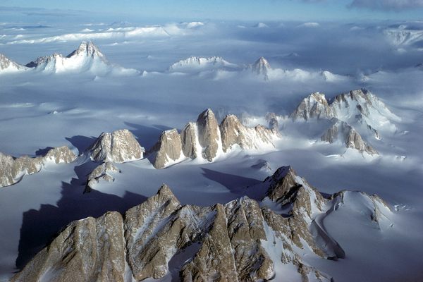 These spectacular granite peaks in the Transantarctic Mountains crop out in a pointy circle known as the Gothic Mountains, midway down the east side of Scott Glacier. The region was first explored in 1933 and 1934