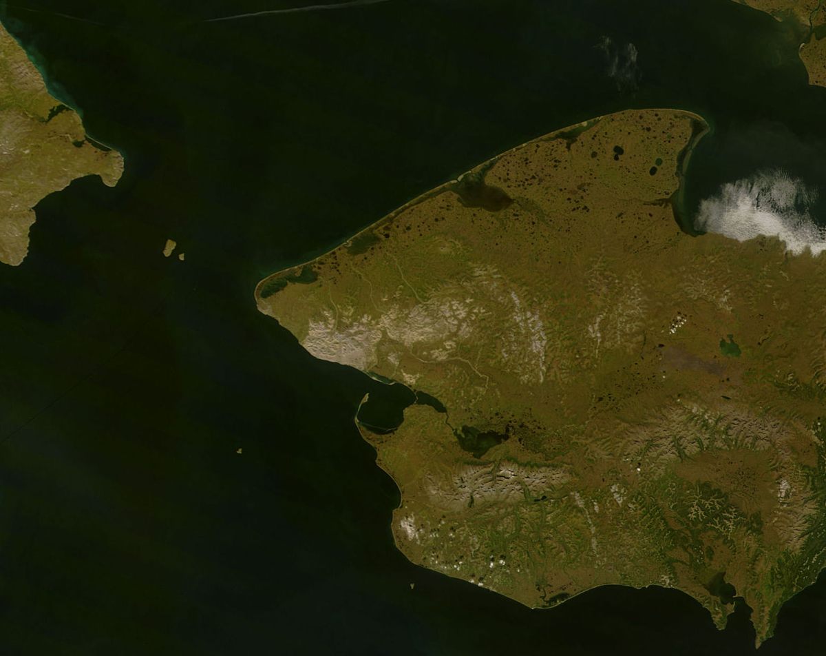 The narrow finger of the Point Spencer spit (center) curves northward on the Seward Peninsula coast. The Russian mainland is visible at upper left of image.