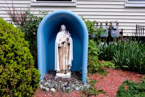 Saint Therese of Lisieux in a bathtub, in front of a house in Somerville, MA.*