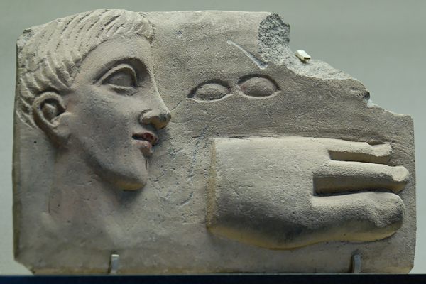 Votive plaque dedicated by a man suffering from sore eyes and a malformed foot.