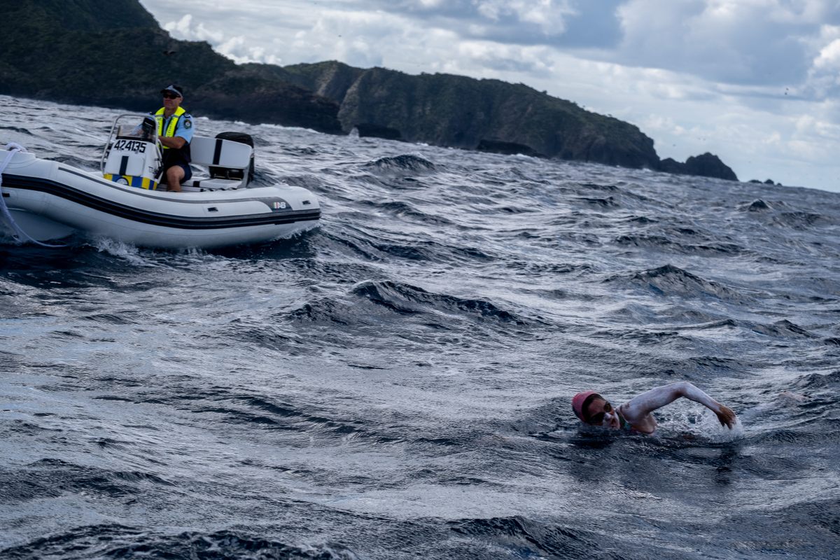 Tischendorf made the swim around Lord Howe Island, a remote volcanic island nearly 500 miles from Sydney, with the help of two safety boats, one of which is shown here. 