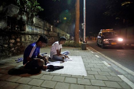 At "study corners" like Abhyas Galli, near the busy junction of Worli Naka in Mumbai, two students enjoy the peace and quiet they can't find at home. 
