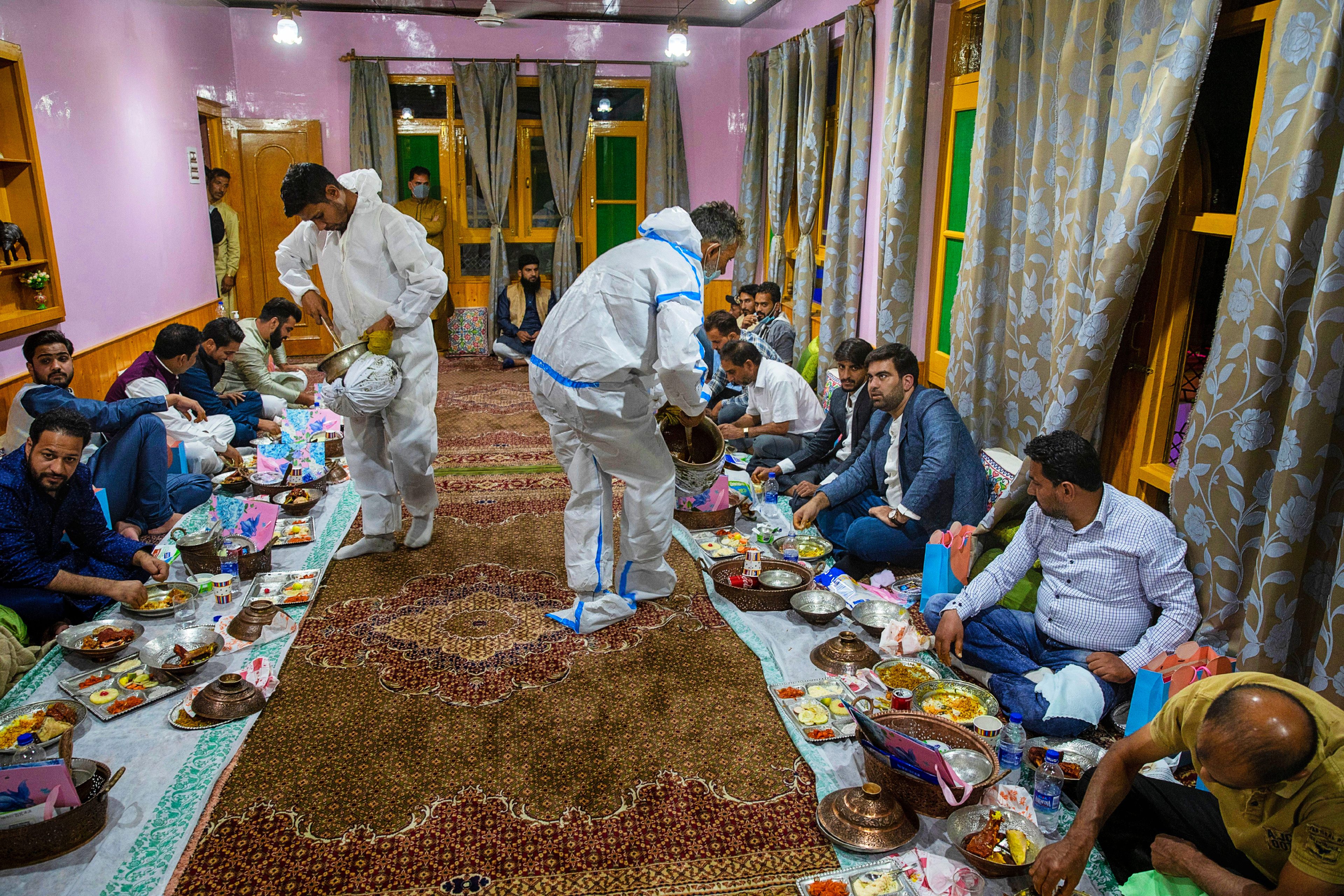 These wazas wear personal protective equipment to serve wazwan during the pandemic.