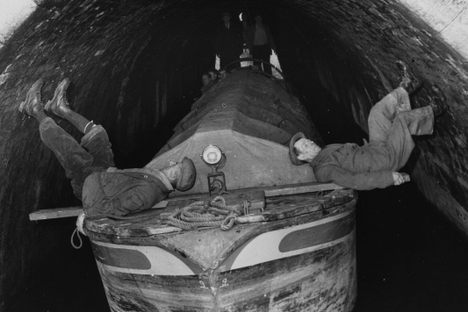 Two leggers moving a barge out of the 500-yard Barnton Tunnel near Northwich, Cheshire. 