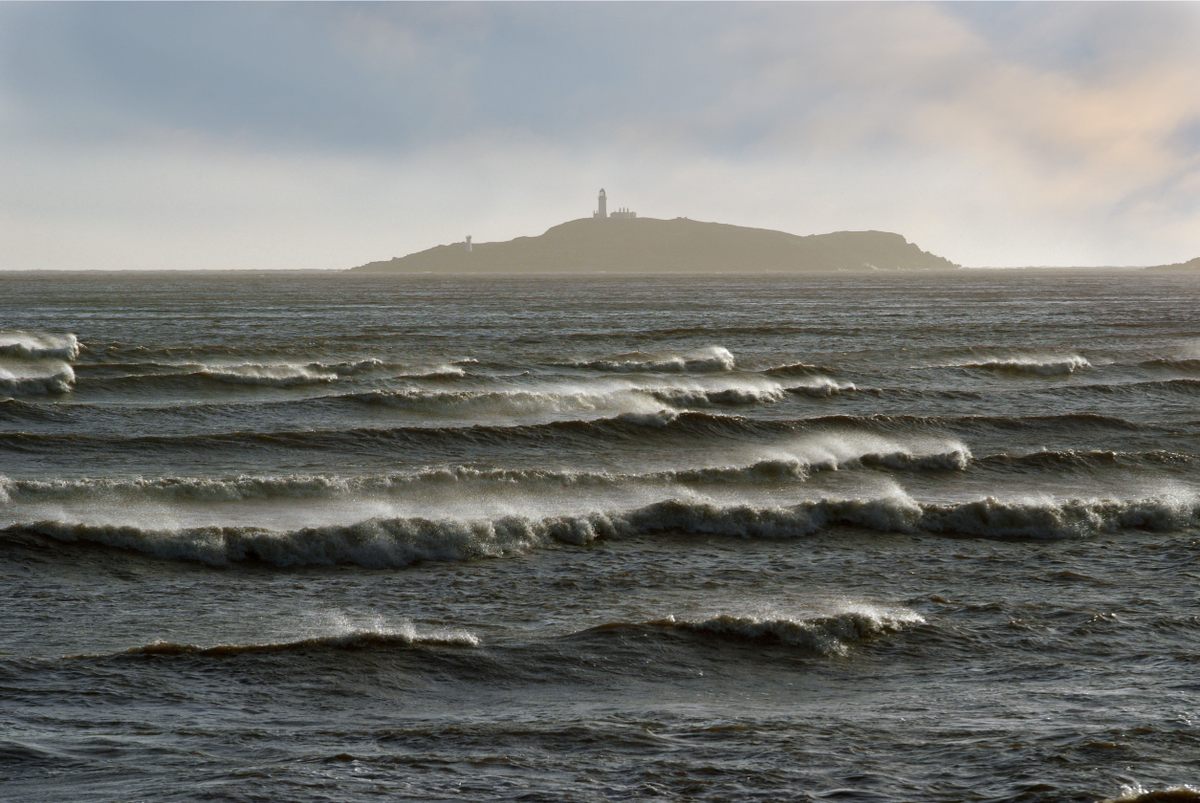 Little Ross Lighthouse in Scotland on a hazy day.