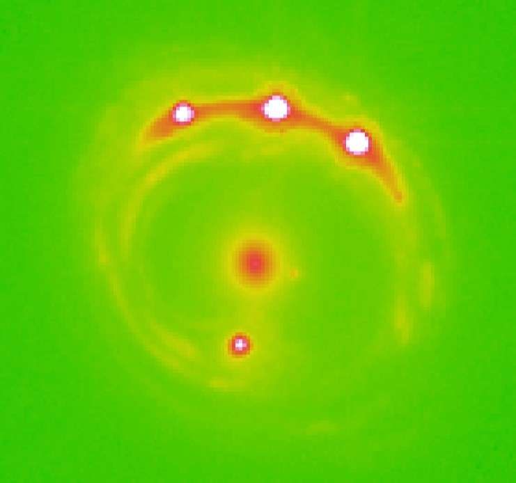 The RX J1131-1231 galaxy (at center) with four quasars lensed around it. Scientists identified evidence of 2,000 planets wandering in this elliptical galaxy.