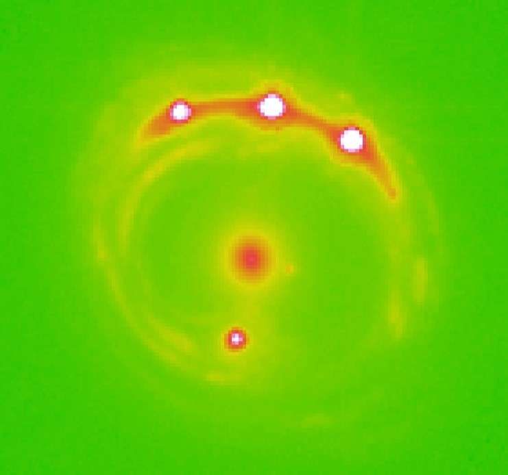 The RX J1131-1231 galaxy (at center) with four quasars lensed around it. Scientists identified evidence of 2,000 planets wandering in this elliptical galaxy. 