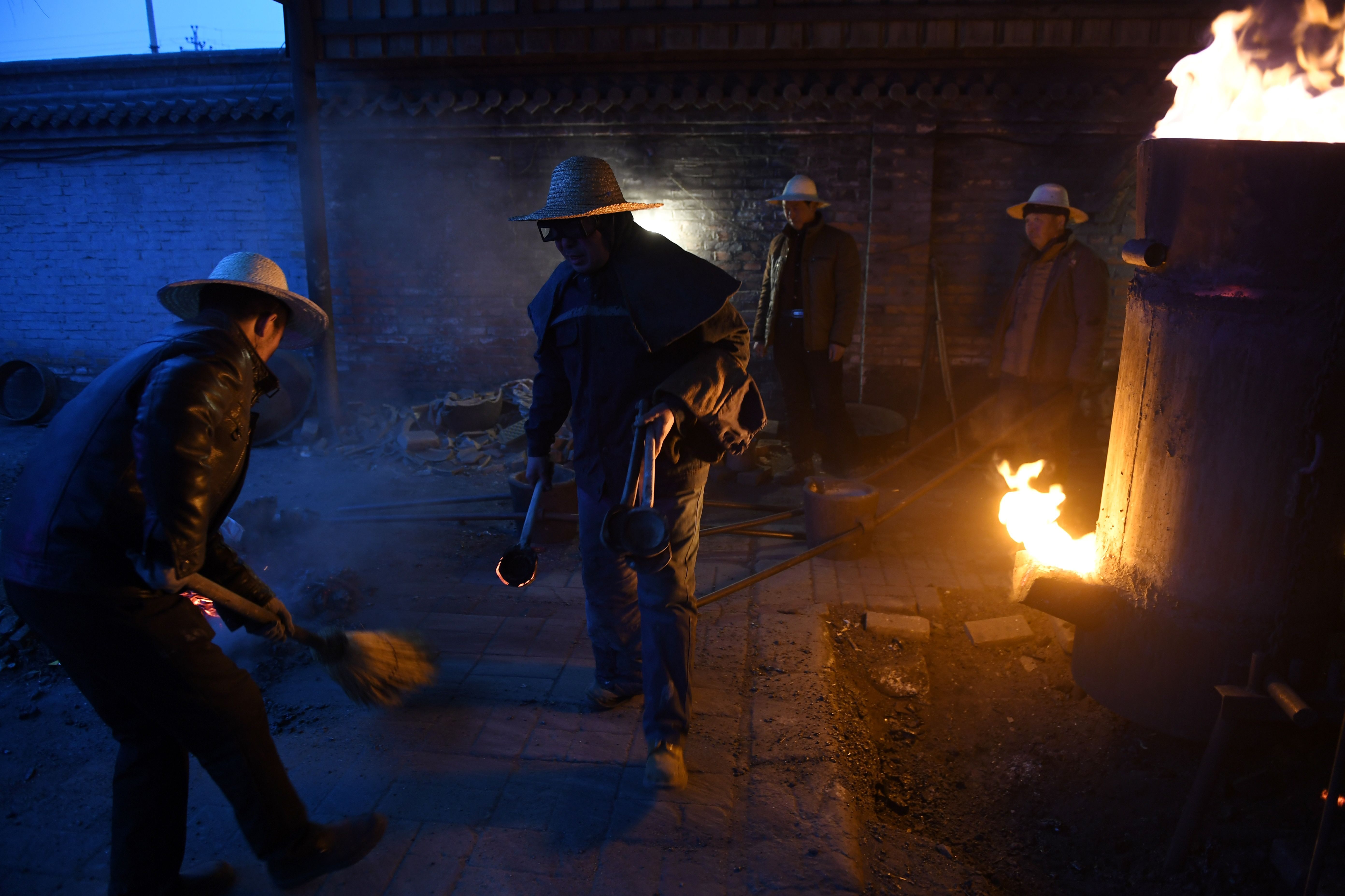 The blacksmiths heat scraps of metal to scorching temperatures in preparation for the display.