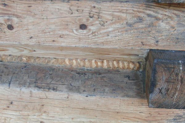 Traditional wood-fibre rope used to seal between  timbers on outside walls