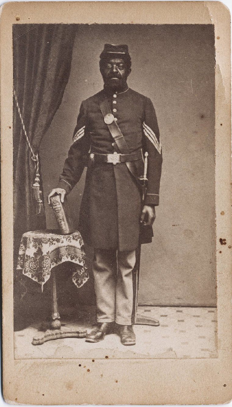 Many soldiers, like this unnamed man, photographed in Hartford, Connecticut in 1863, posed in their uniforms and with props, from books to weapons.