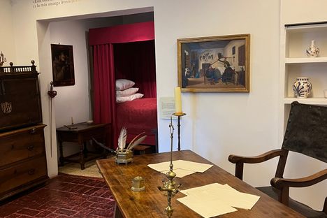 An antique desk and writing utensils inside the home.