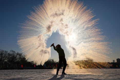 Instant winter magic happens when a woman throws hot water into the air. The water immediately condenses into ice crystals at temperatures -16 degrees Fahrenheit, in Shenyang in northeastern China, on January 8, 2021.