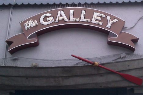 Nautical-themed signs hang outside this colorful restaurant
