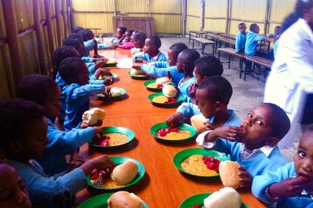 Lunch at this Nigerian elementary school includes rice, bread, and fruit.
