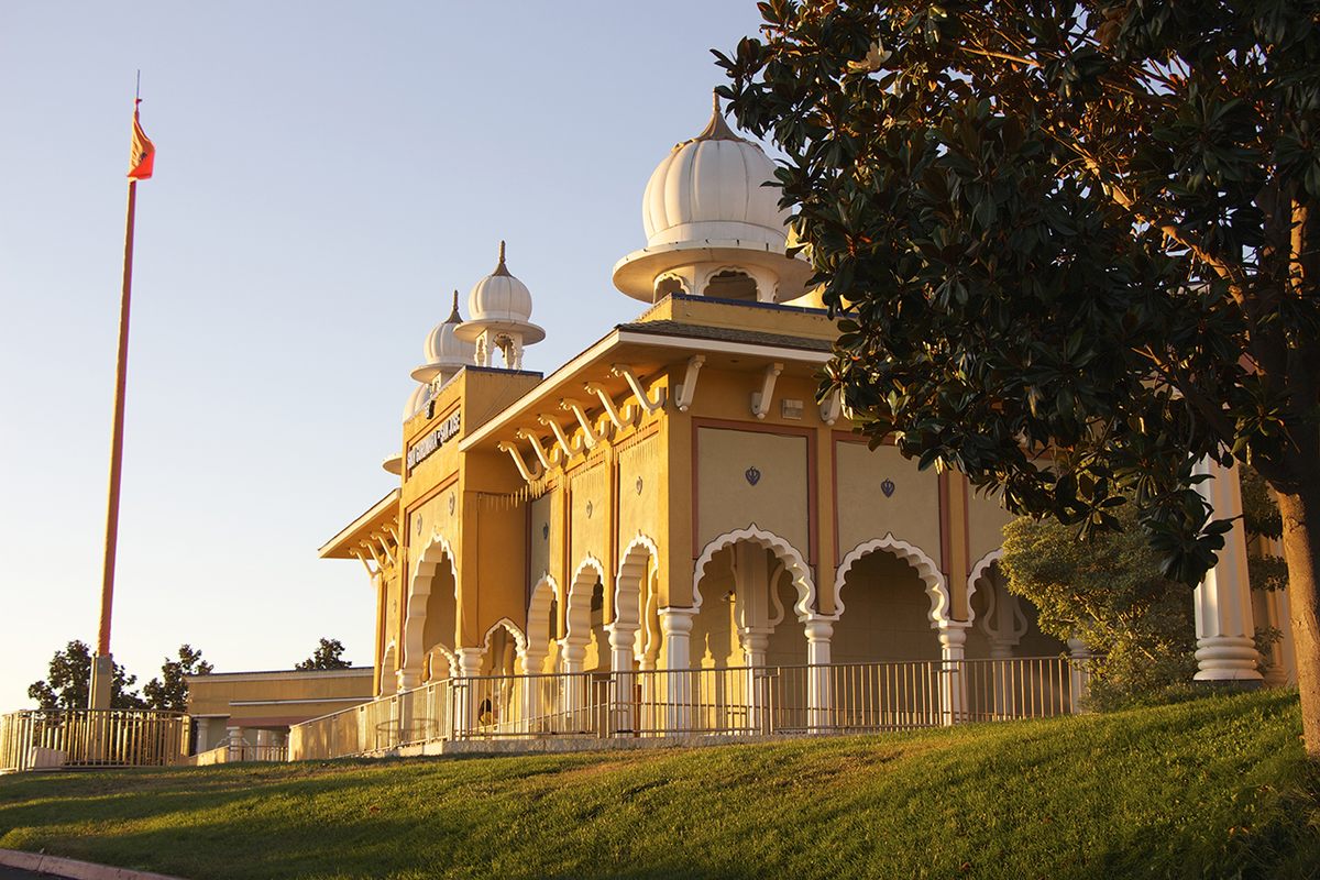 San Jose's gurdwara, with its the <em>Nishan Sahib</em> flag flying in front.