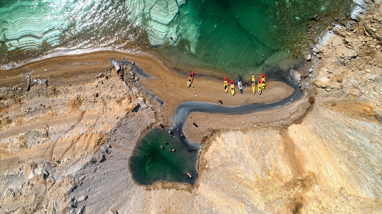 Kayakers visit a slumped sinkhole on the Dead Sea Coast. 