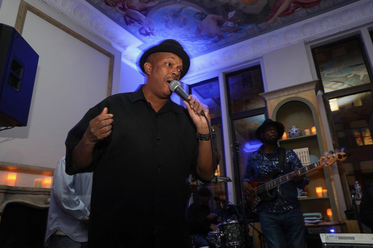 Mike Yung belts it out while partygoers dance.