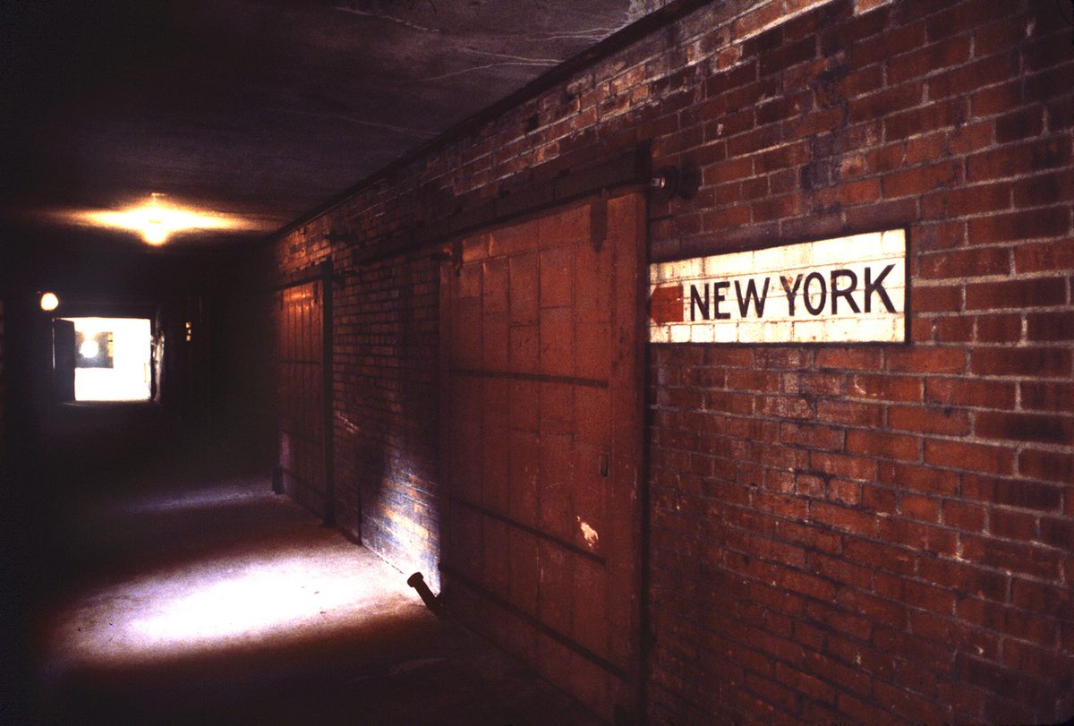 A sign points the way to the ferry that took processed immigrants to new lives in New York City.