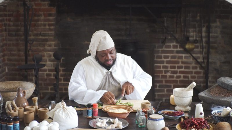 Dontavius Williams thanks Caesar, the 18th-century enslaved chef who managed Stratford Hall, before beginning a demonstration in the historic hearth where Caesar once cooked.