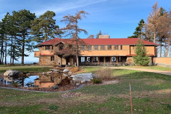 Back of house closest to road featuring the pond.
