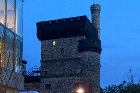 A light on in one of the top rooms of Usen Castle. On the left is the new dormitory for which part of the castle was demolished.