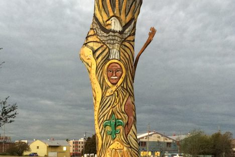 Symbols of New Orleans carved into the trunk of the tree