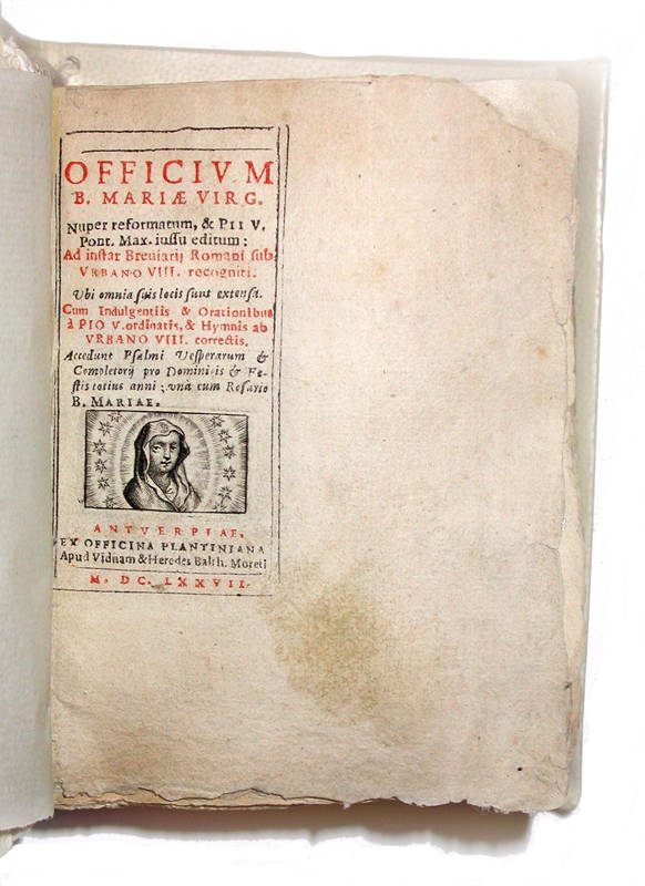 From 1677, <em>Officium Beatae Mariae Virginis</em>, in which a miniature layout sits in a larger book because the pages were never cut.