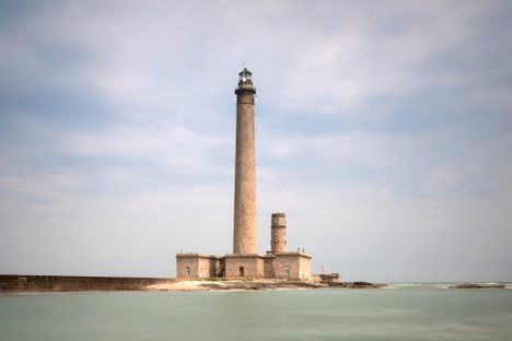 The current lighthouse stands with the original in its shadow.