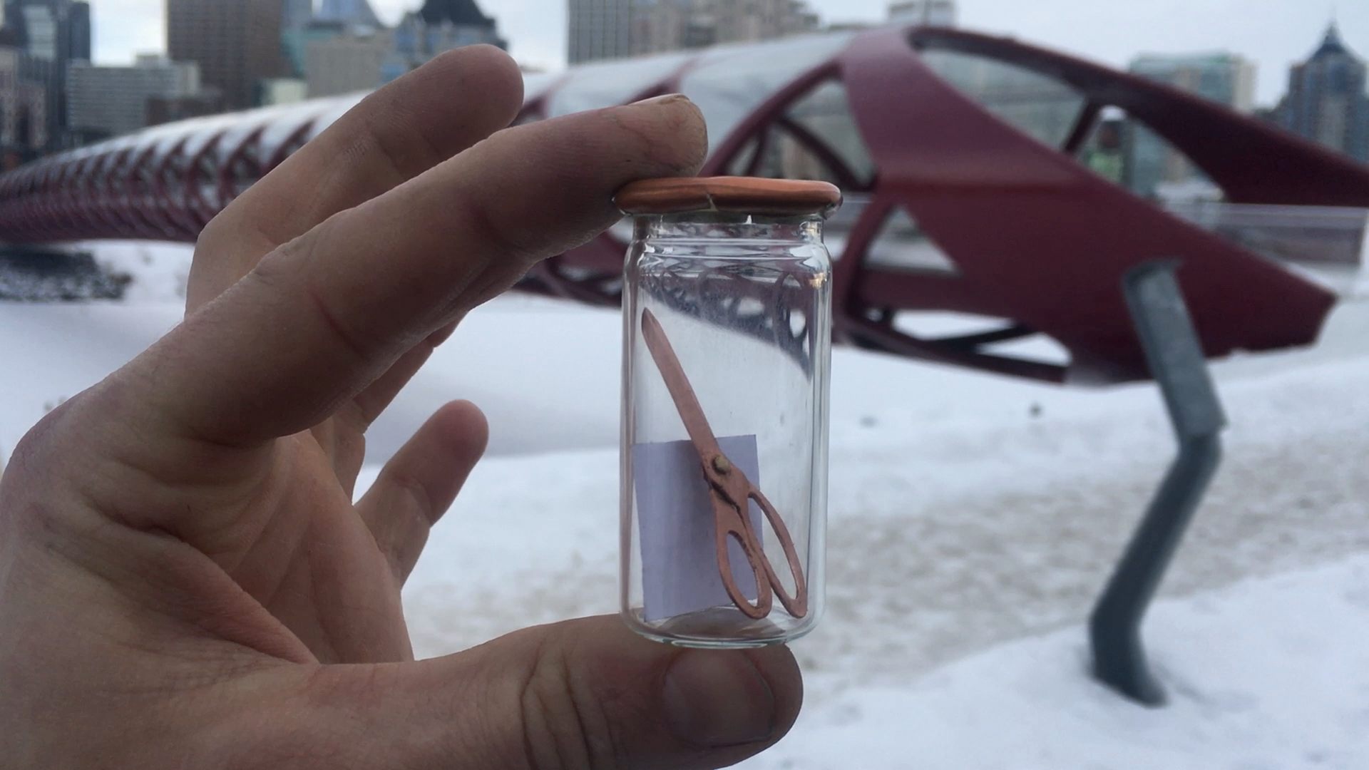 Brown hides a tiny pair of scissors for a fan to find.