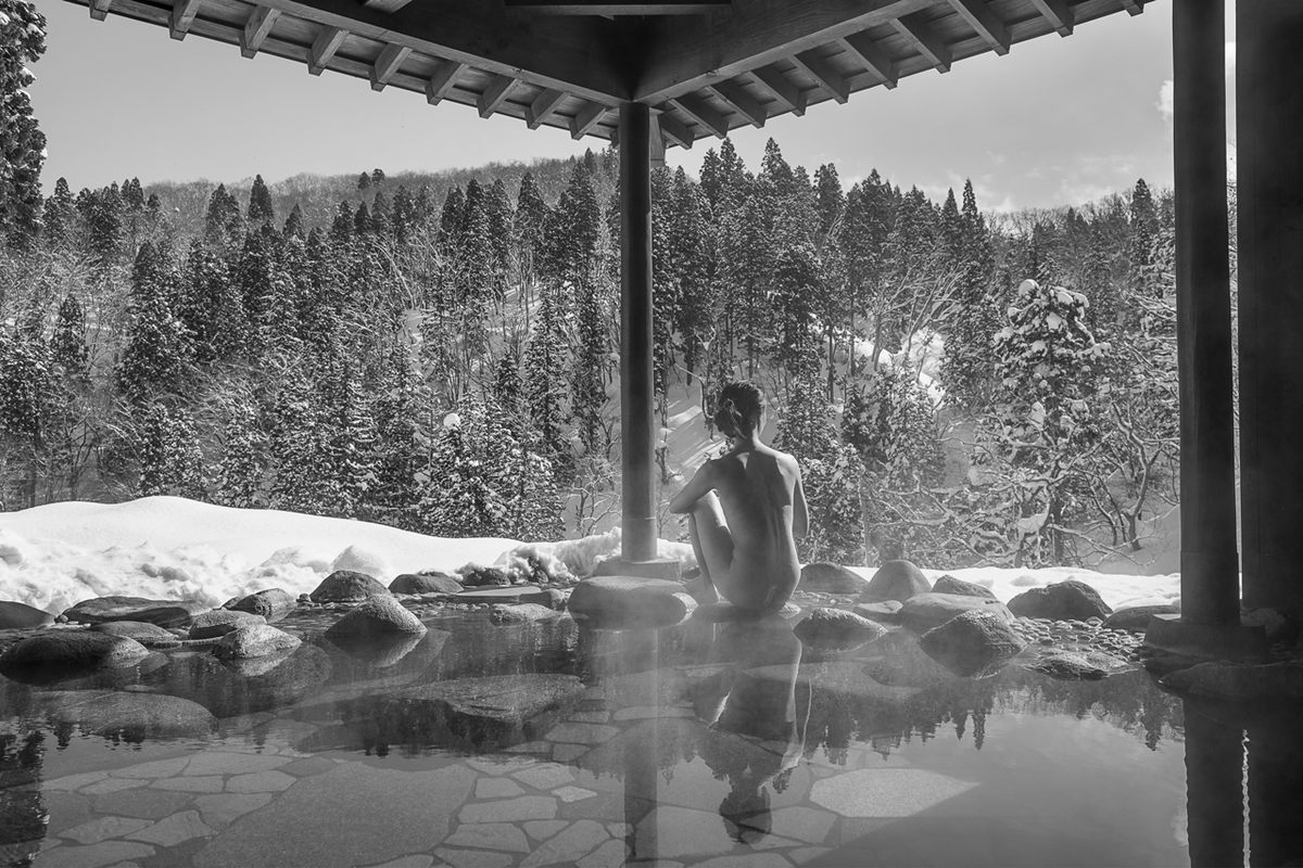 A bather does <em>yukimi</em> (snow gazing) at the Takimikan Ryokan above the Ginzan Onsen in Yamagata Prefecture.