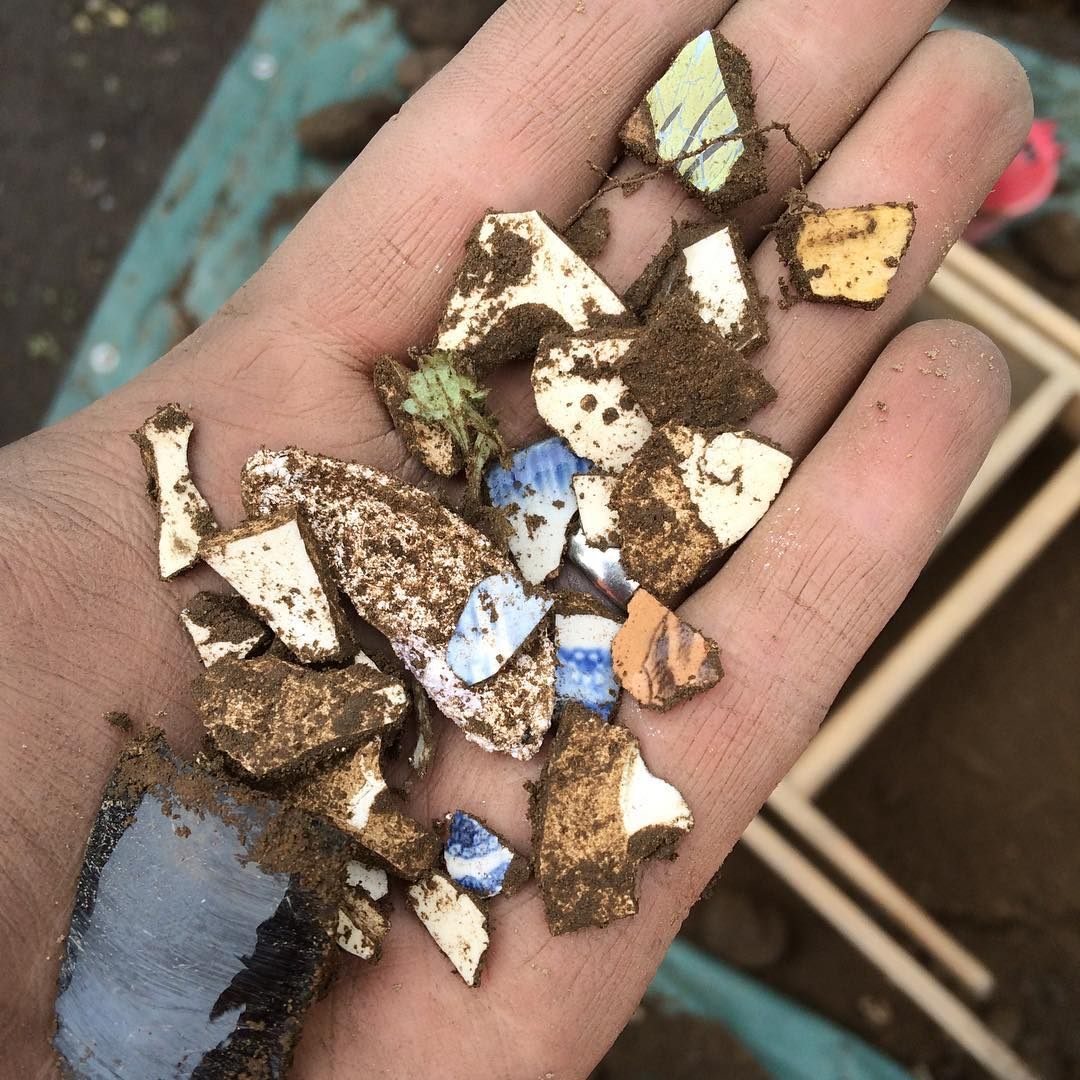 Joseph Bagley holds some18th and 19th century ceramic shards, unexpectedly unearthed at the Malcolm X House in Roxbury.