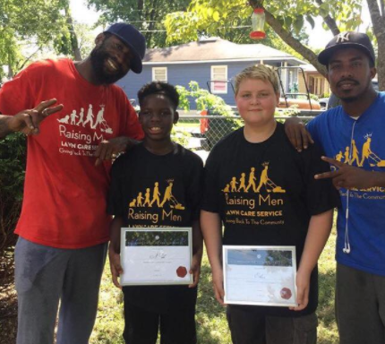 Smith with some of the kids from the program, celebrating 50 lawns.