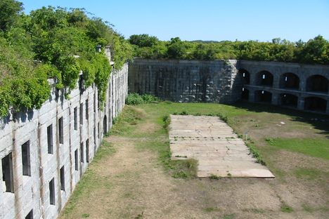 The fort is green with overgrown plant life, which adds to its charm. 